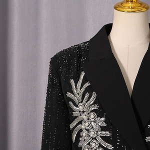 Detail of silver plant embroidery with pearls and rhinestones on black blazer lapel