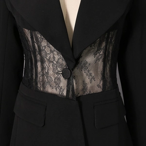 Detail of slim-fit black blazer featuring elegant sheer lace cutouts at the waist area