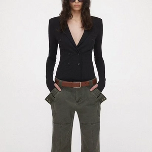 Detail of slim-fit double-breasted black bodysuit top with V-neck and long sleeves
