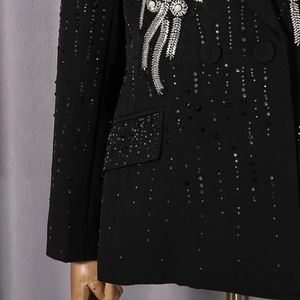 Detailed view of black blazer with hand-sewn sequins, pearls and rhinestone fringe