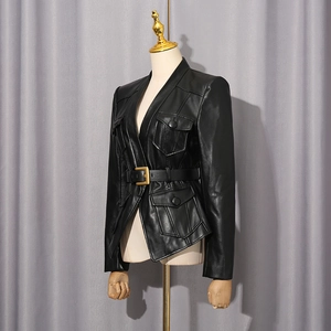 Detail of black faux leather jacket featuring four flap pockets and metal buckle belt