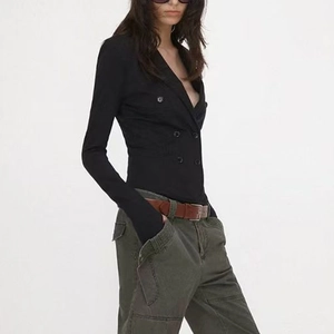 Close-up of slim black long-sleeve bodysuit with double-breasted buttons and V-neckline