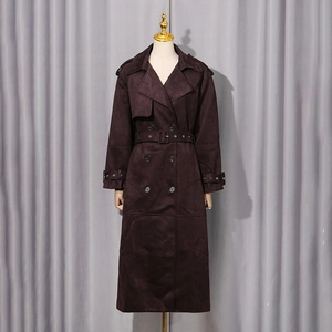Close-up of deep brown suede long coat with classic lapels and double-breasted buttons