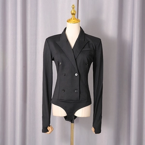 Detail of black double-breasted bodysuit featuring a suit collar and thumbhole sleeves