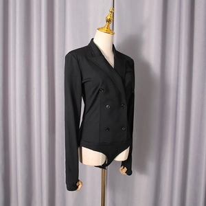 Detail view of black double-breasted bodysuit with peak lapels and tailored long sleeves