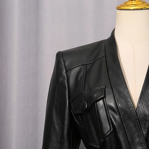 Detail of black leather jacket showing quilted lapels and flap pocket on a mannequin