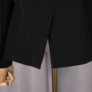 Detail view of the back vent and tailored hem of a black slim-fit sheer blazer jacket
