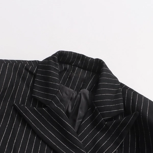 Detail of peak lapel and texture on black striped business casual blazer for women