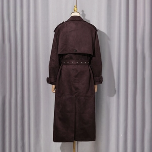 Detail view of burgundy faux suede trench coat back with storm flap and belted waist