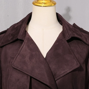 Detail of classic wide lapel and texture on dark brown faux suede trench coat