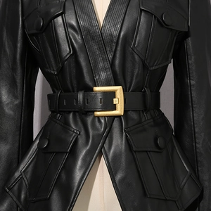 Detail of black leather jacket featuring four cargo pockets and a matte gold belt buckle