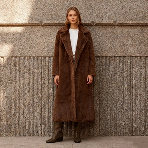 Detail of premium brown faux fur coat with large lapels and textured ankle-length design