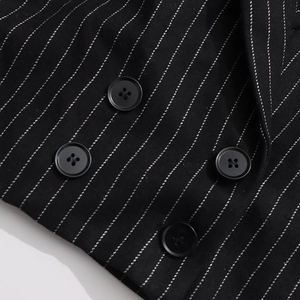 Detail of black pinstripe blazer featuring high-quality double-breasted round buttons