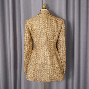 Back view of gold tweed blazer jacket showing tailored waist and textured woven fabric