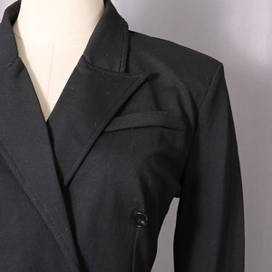 Detail of notched lapel and shoulder line on a slim fit black bodysuit blazer for women