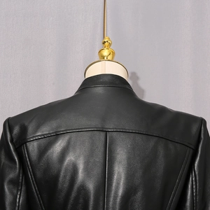 Detail view of black faux leather jacket back with sleek seams and knit collar detail