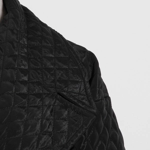 Detail of diamond quilted stitching and textured collar on this black winter jacket coat