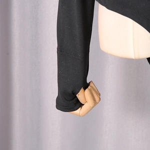 Detailed macro view of black bodysuit cuff featuring a functional thumbhole design