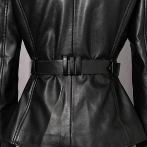 Close-up of the adjustable waist belt and back detail on a black leather jacket