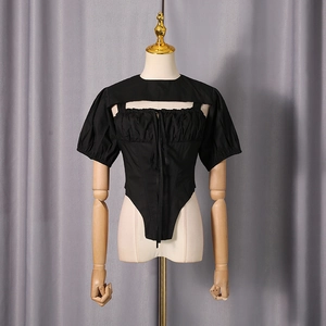 Detailed view of black corset top with puff sleeves and unique rectangular cutout