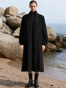Long black quilted coat for women with classic diamond pattern and stand collar design