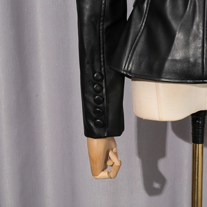 Detailed close-up of a black PU leather jacket cuff featuring five decorative buttons