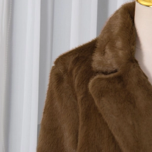 Close-up of deep brown faux fur coat showing soft texture and wide lapel collar
