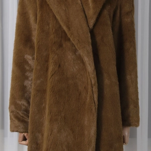 Detail shot of brown faux fur coat showing texture, notch lapel and long sleeves