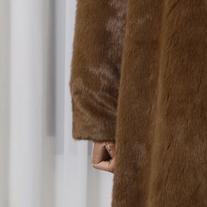 Detailed macro shot of premium caramel brown faux fur texture on a thick wool coat