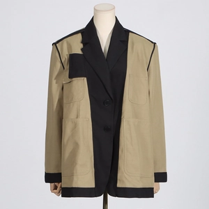 Detail of khaki and black contrast blazer with four utility pockets and button closure