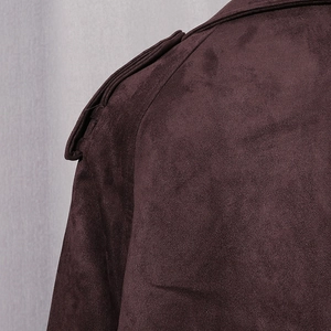 Detail shot of shoulder epaulette on a dark burgundy faux suede long trench coat jacket