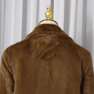 Detail view of smooth faux fur texture on the back collar of a brown wool coat