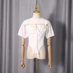 Detail of white puff sleeve top with lace-up inner layer and hollowed-out texture
