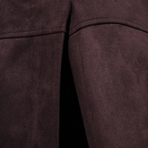 Close-up of premium suede fabric showing fine texture and meticulous single-stitch sewing