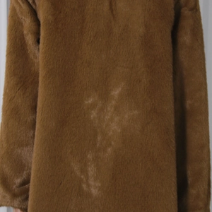 Detailed macro view showing the soft texture and thick brown faux fur fabric of the coat