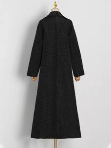 Women's long black diamond-quilted coat with lapel collar and ankle-length silhouette