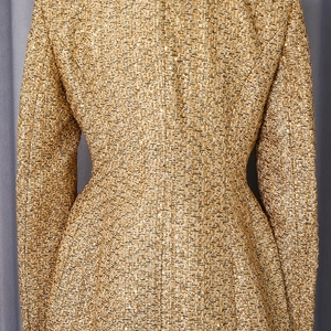 Detail of gold tweed jacket with shimmering metallic fibers and slim fit waist design
