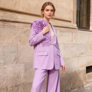 Detailed view of the 3D pleated lavender rose flower on the shoulder of a luxury suit