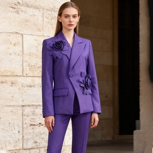 Detail of elegant purple blazer featuring 3D floral accents and premium fabric texture