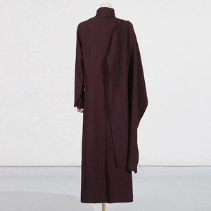 Close-up of elegant asymmetrical draped folds on a long wine red trench coat for women