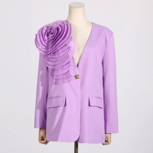 Detailed view of lavender blazer featuring a large 3D floral accent and gold embossed buttons