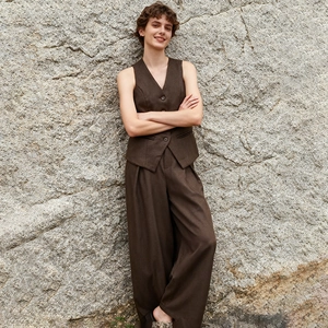 Detailed close-up of dark brown vest and wide-leg trousers set with button details