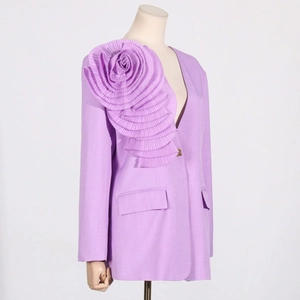 Detailed view of the large purple 3D pleated flower on a long-sleeved blazer