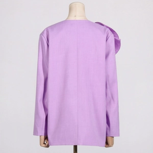 Detail view of the back of a light purple blazer with unique shoulder pleats and clean lines