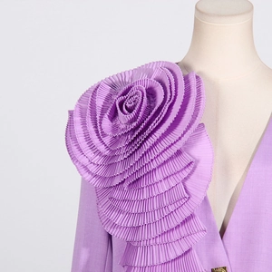 Detail of lavender blazer showing intricate 3D pleated flower applique on the neckline