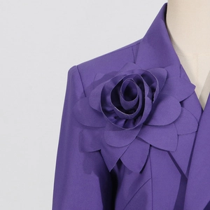 Detail of a purple blazer featuring a large 3D fabric rose on the lapel and sharp shoulder
