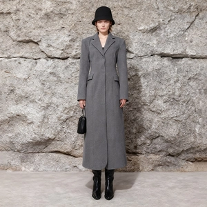 Close-up of elegant grey wool coat with notch lapels and textured minimalist fabric
