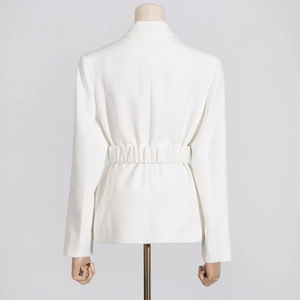 Detail of white long-sleeved blazer featuring a structured elastic cinched waist on the back