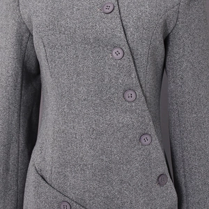 Detailed macro view of dark grey wool blend fabric and irregular button closure