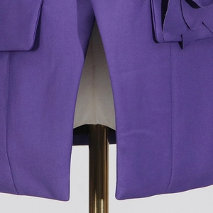 Detail view of purple blazer back vent and premium textured fabric craftsmanship